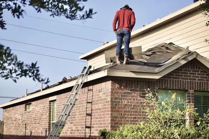 Professional roofer working on a residential roof in Comps Crossroads